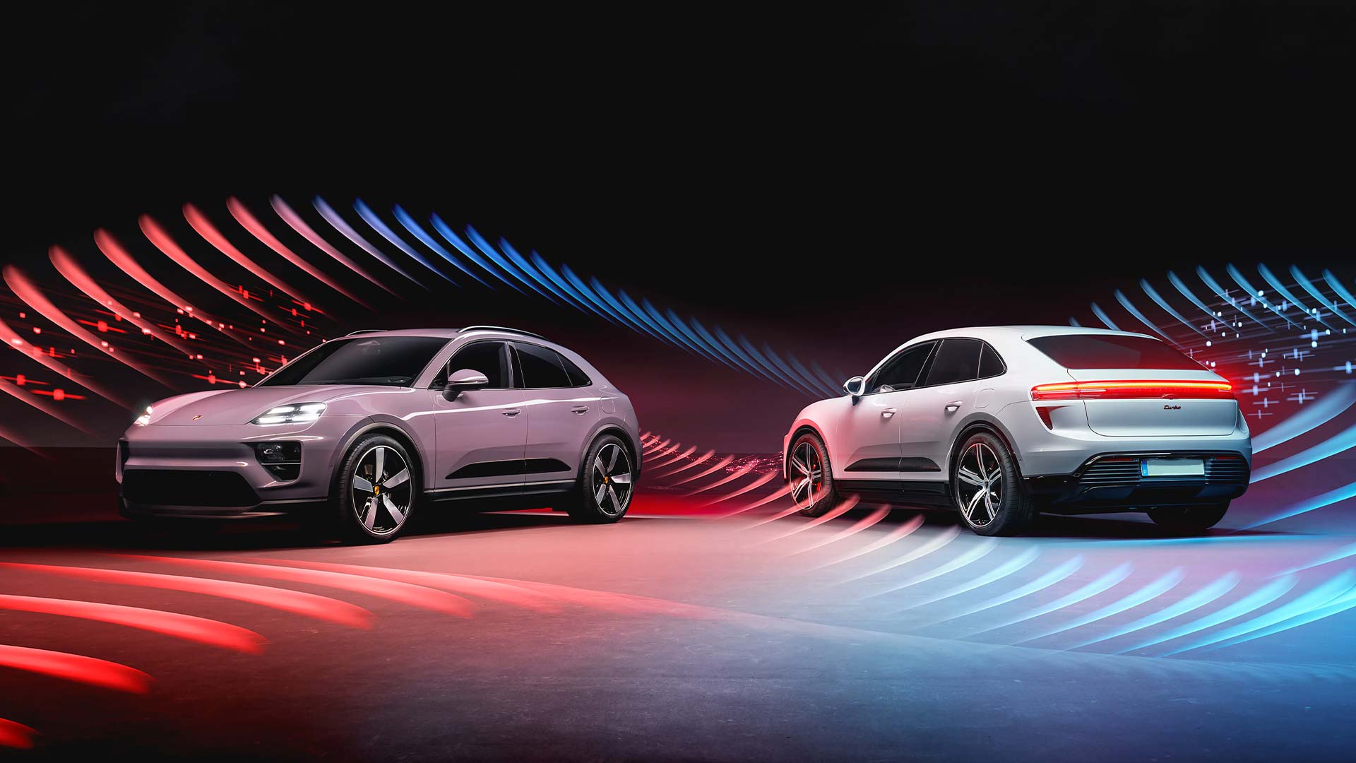 two porsche macans with abstract red and blue background