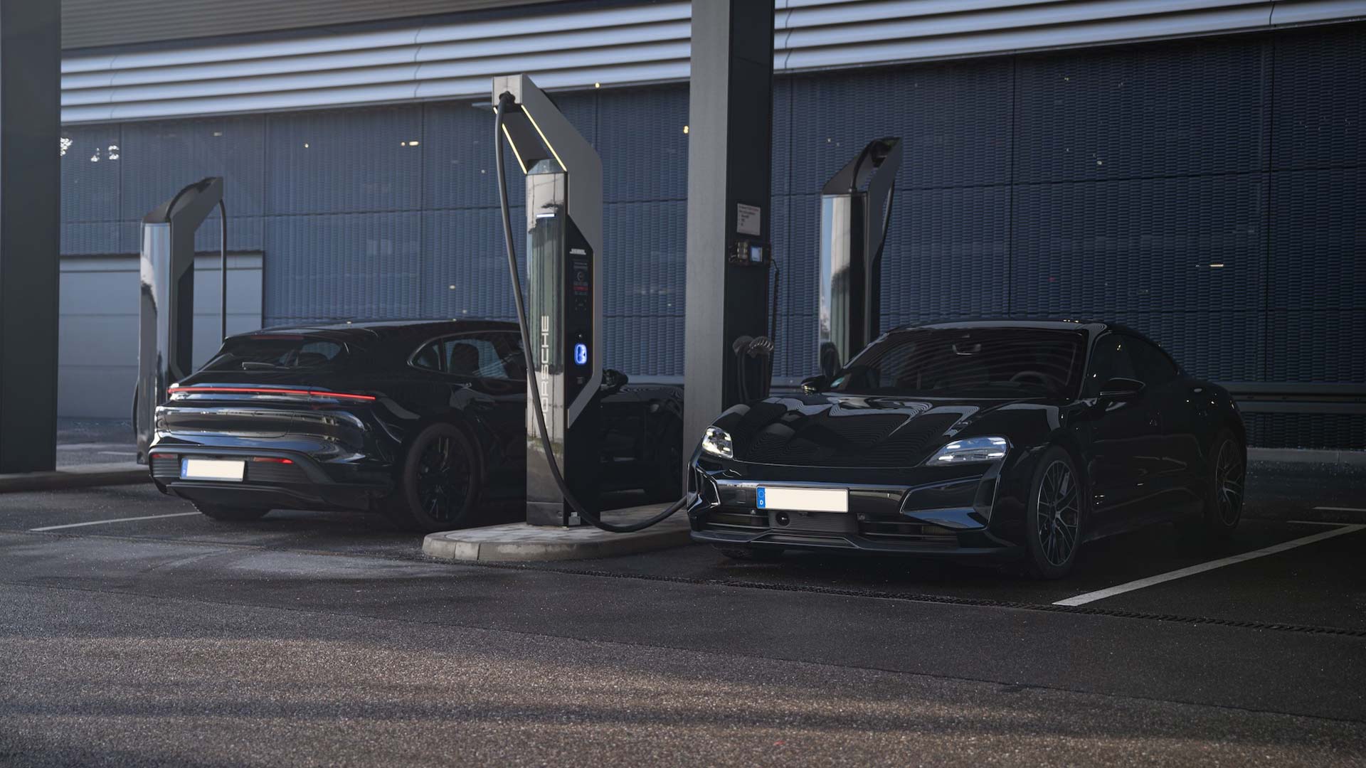 two 2025 porsche taycans at charging station