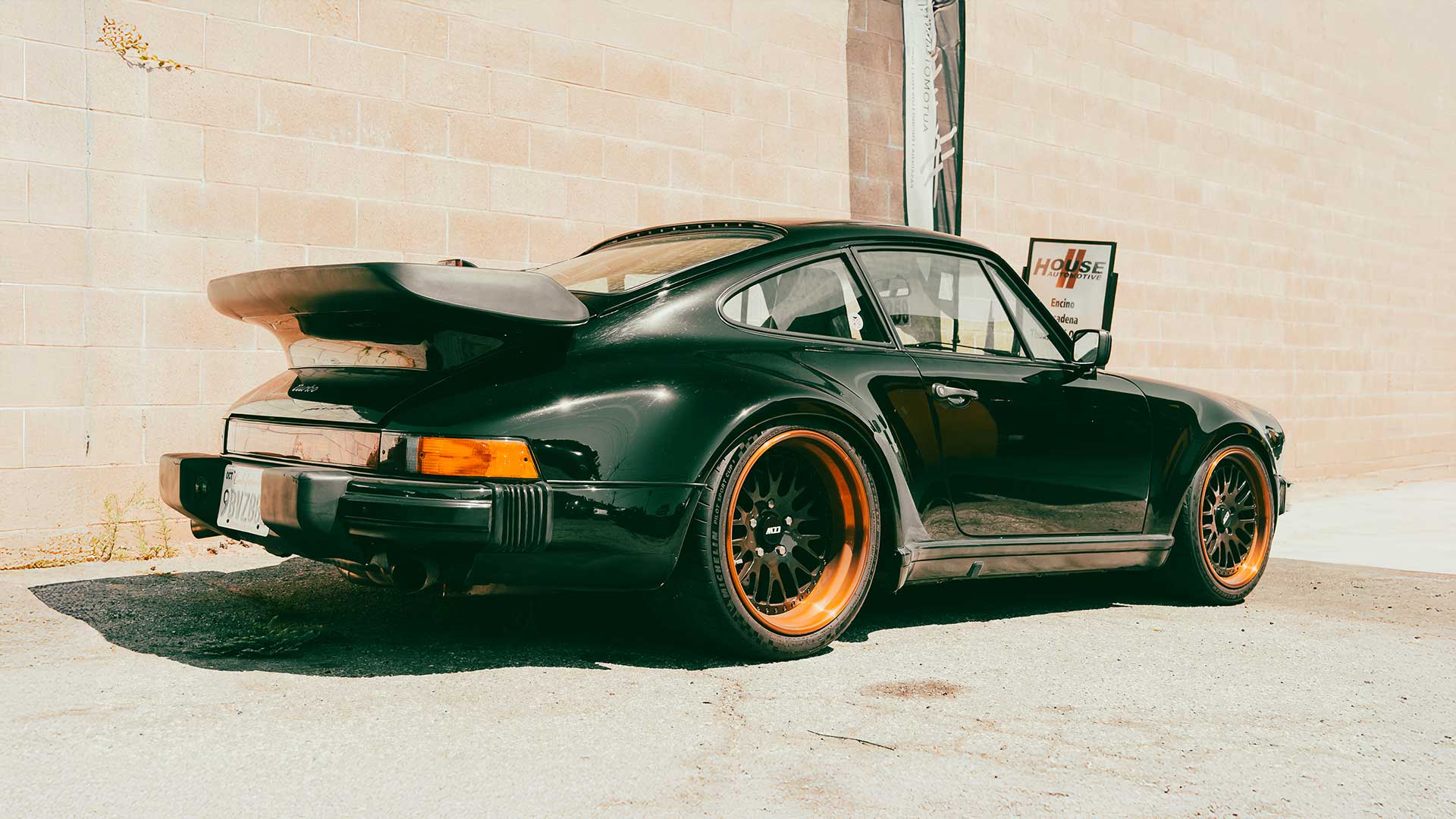 black 930 porsche 911 turbo at house