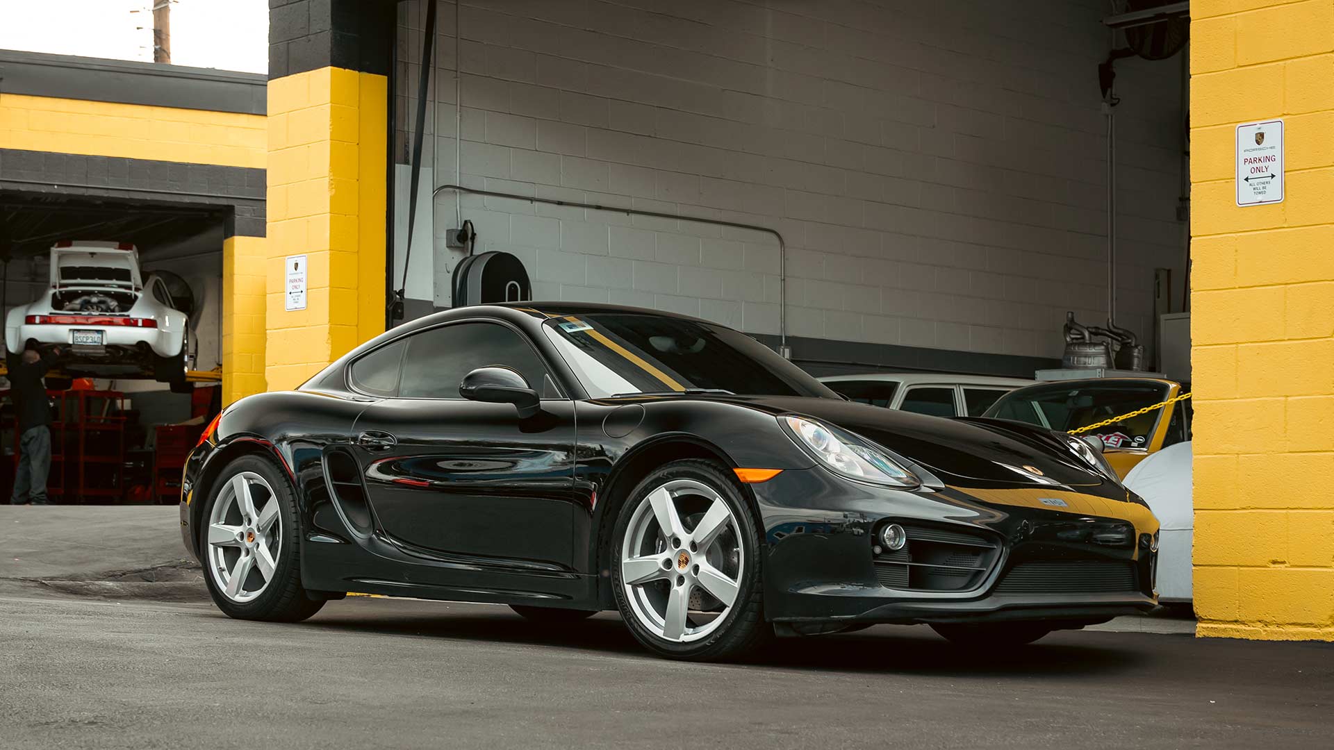 black porsche 718 at house automotive porsche service center