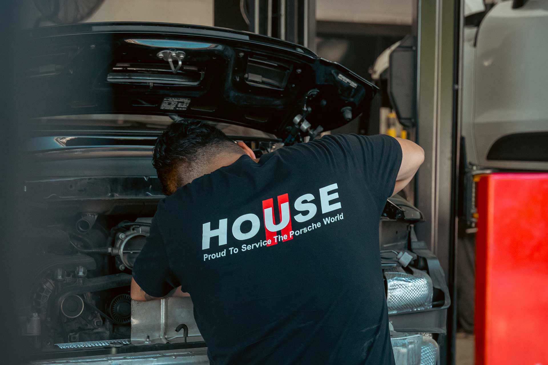 house automotive tech working on porsche 911