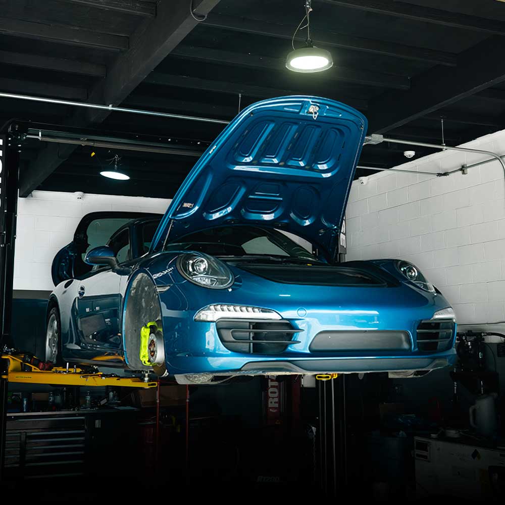 blue porsche 911 991 on lift at house automotive porsche service center los angeles