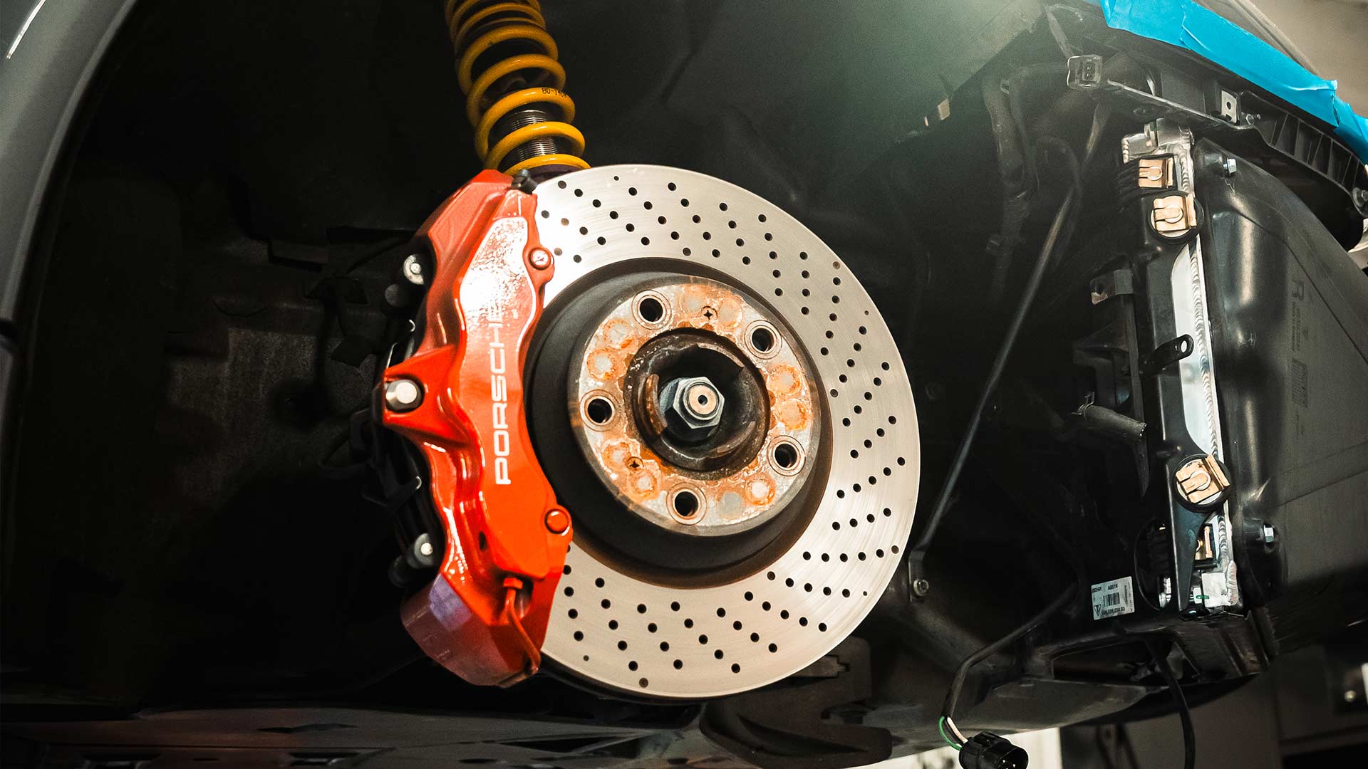 red porsche brake calipers and drilled rotors at house ag