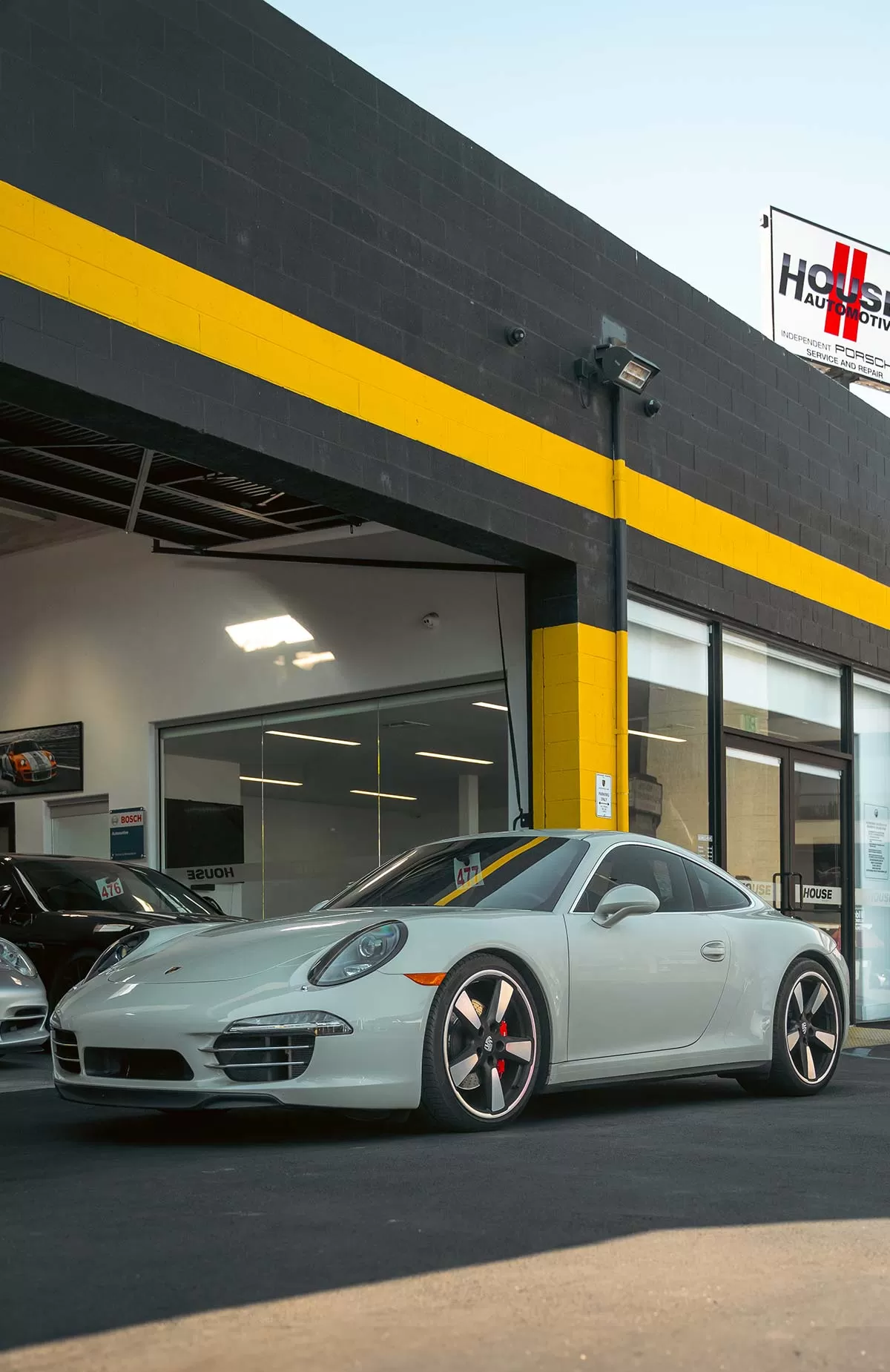 gray porsche 911 outside shop