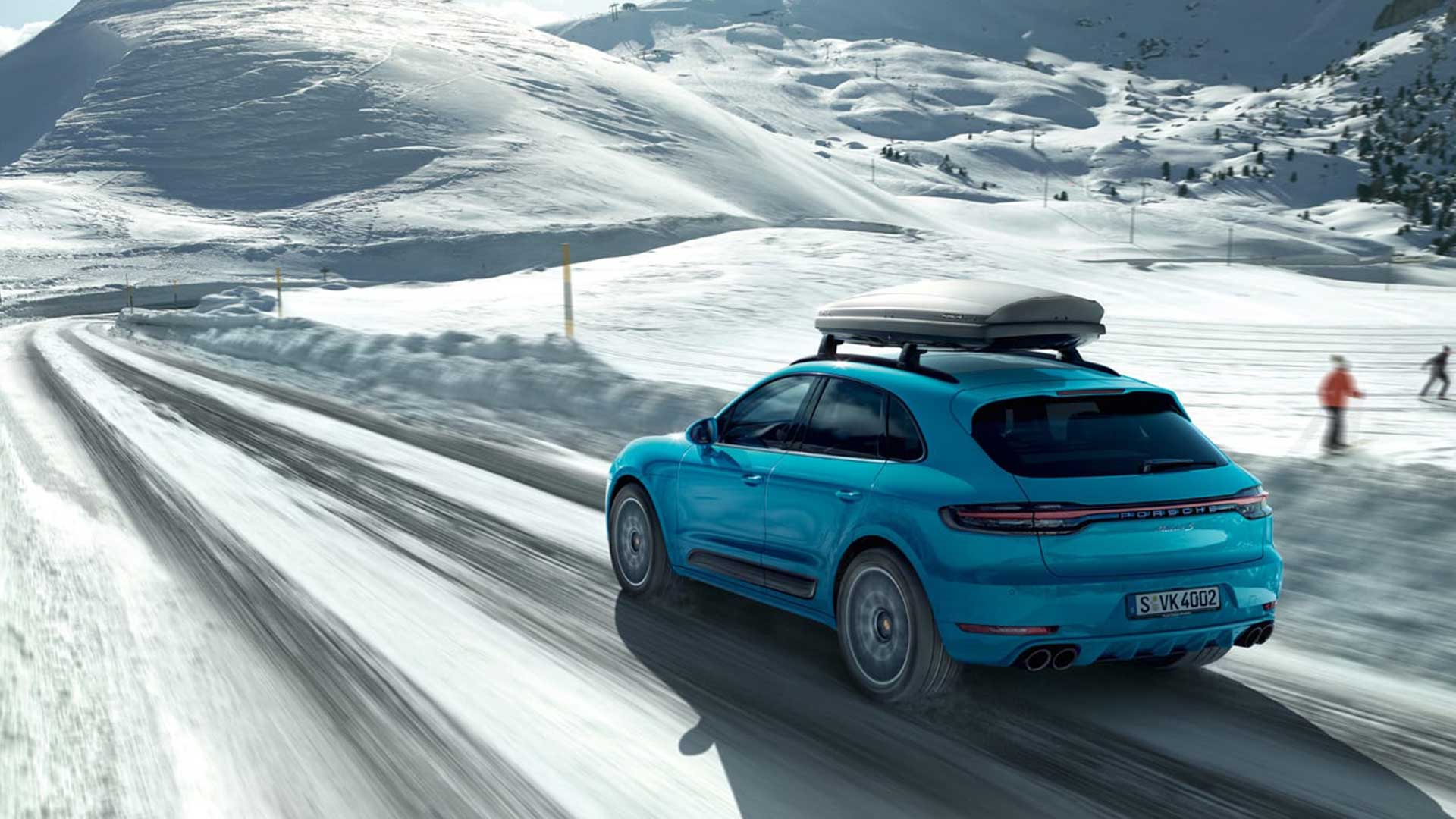 porsche macan driving on snow covered winter road