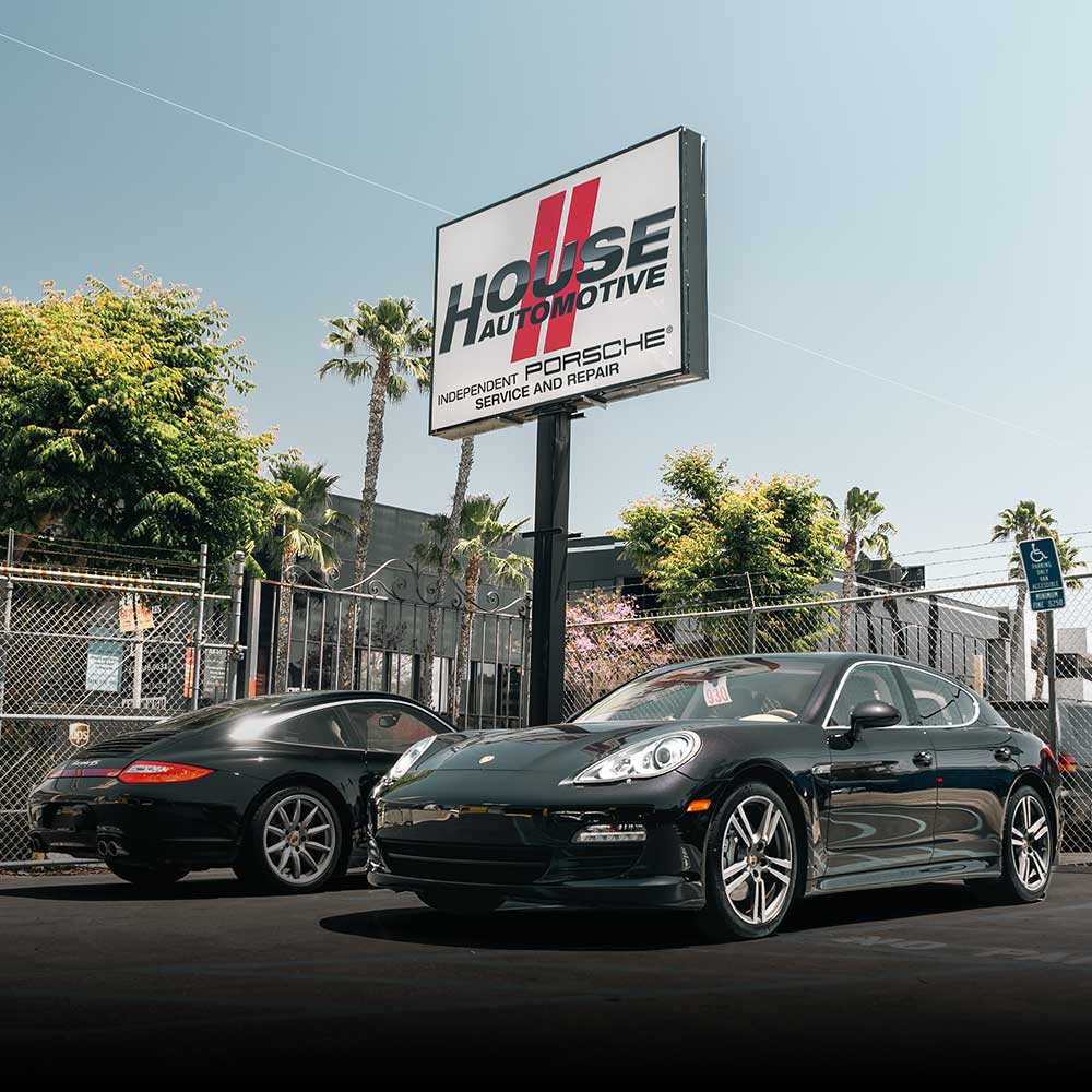 black porsche panamera parked under house automotive encino sign