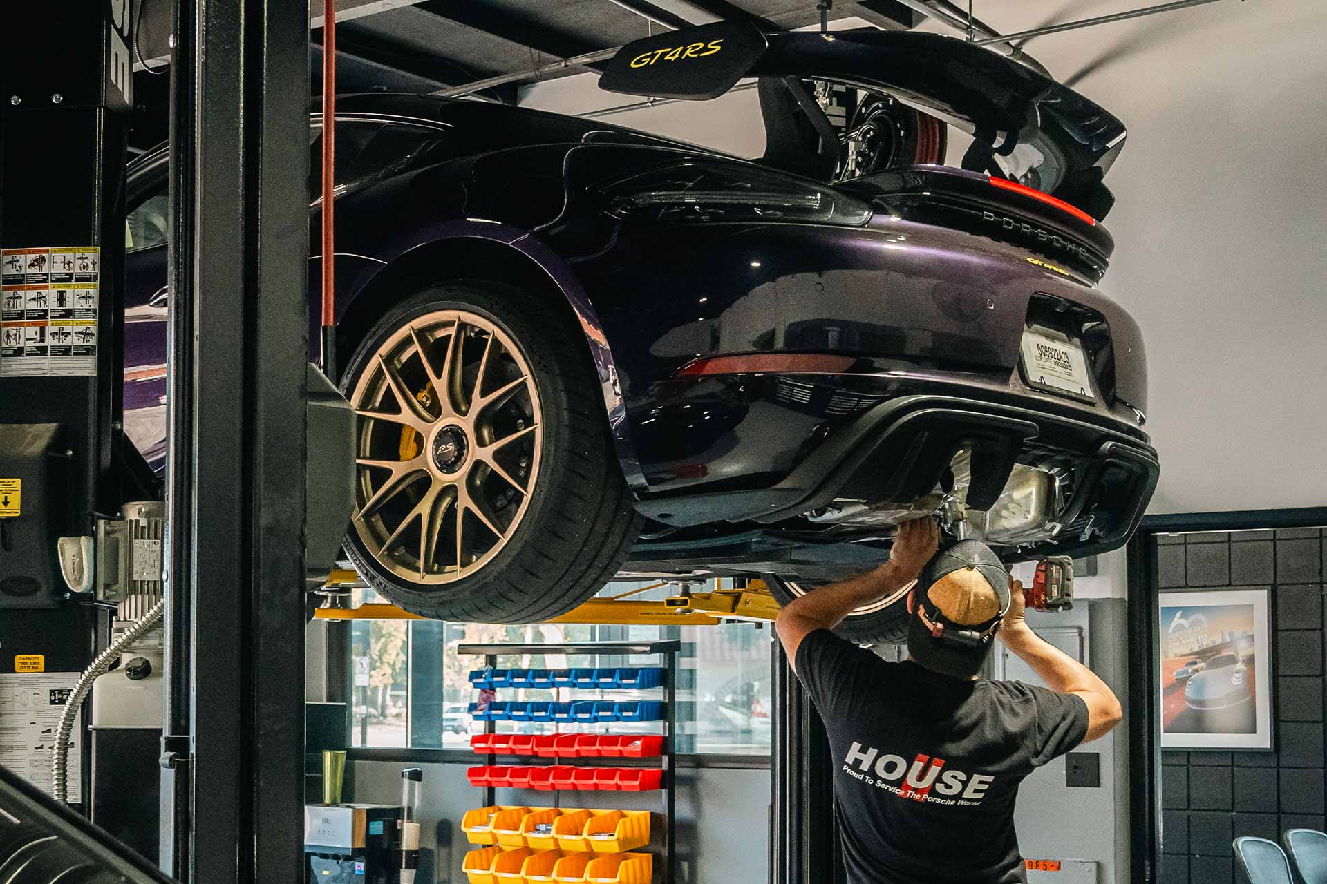 porsche gt4rs receiving professional service on hydraulic lift at house automotive repair center