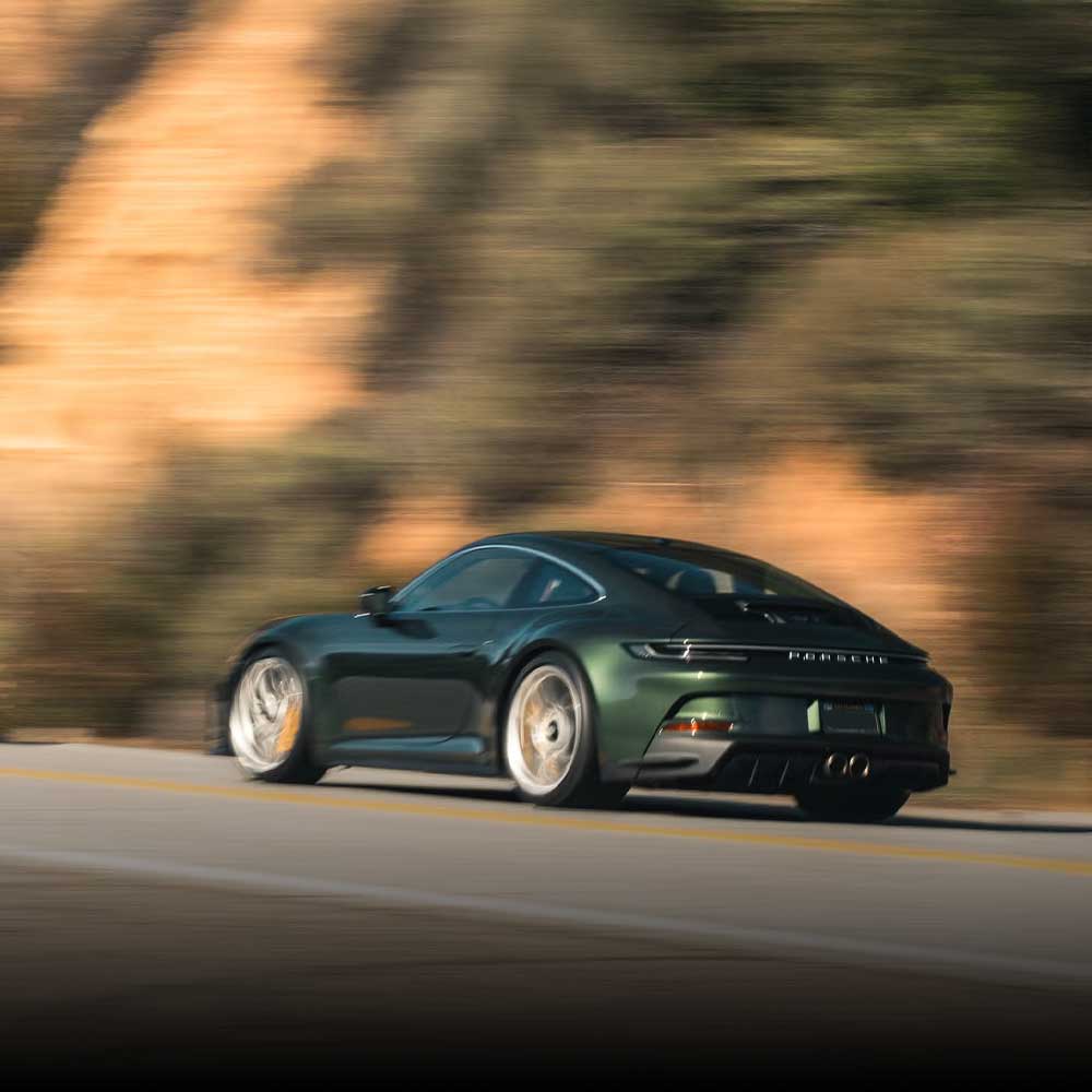 green porsche 911 gt3 touring on socal canyon road