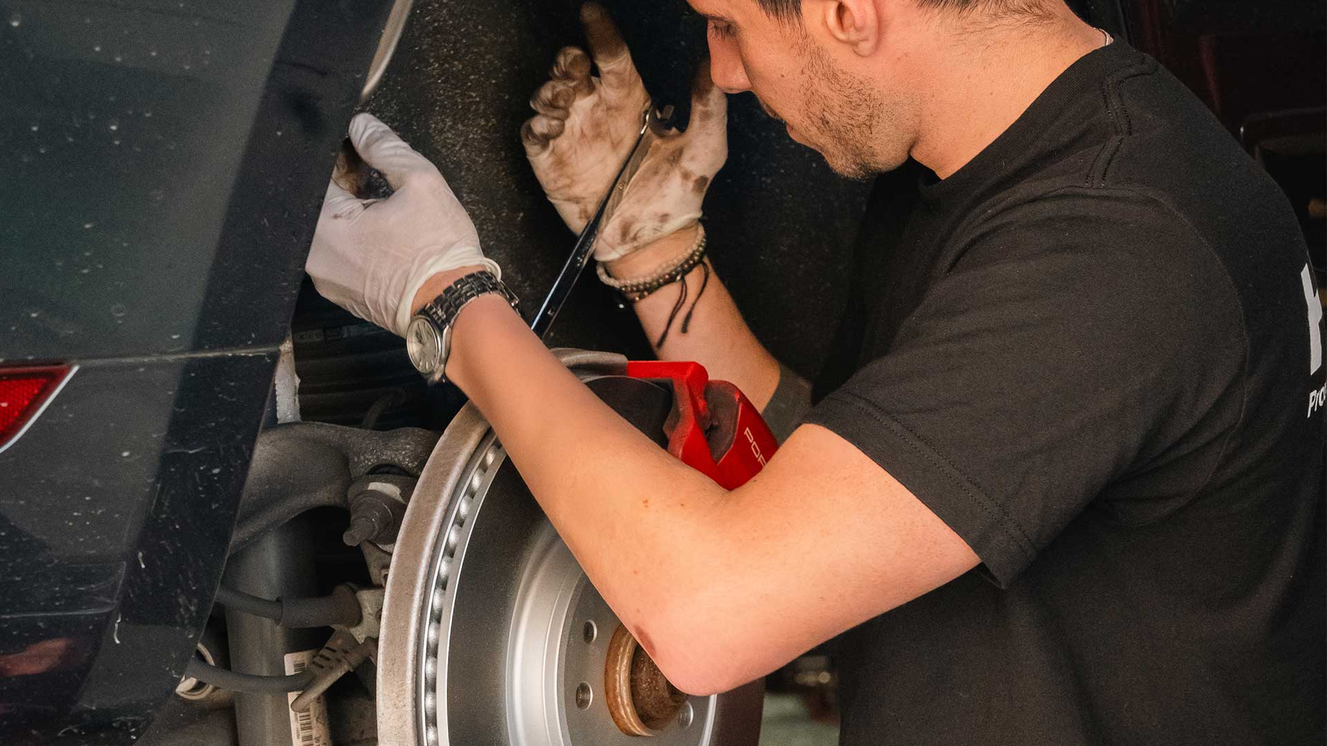 porsche tech at house automotive working on brakes