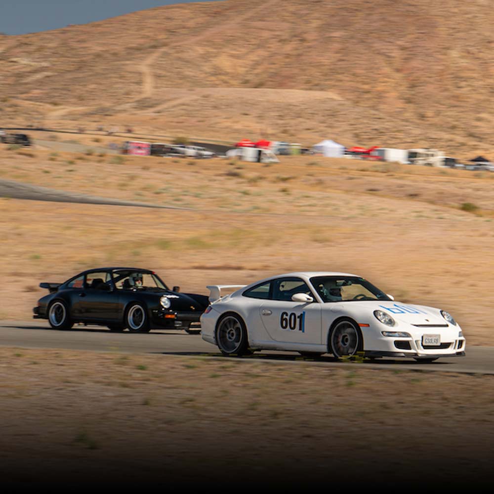 two porsches on the track at willow springs raceway