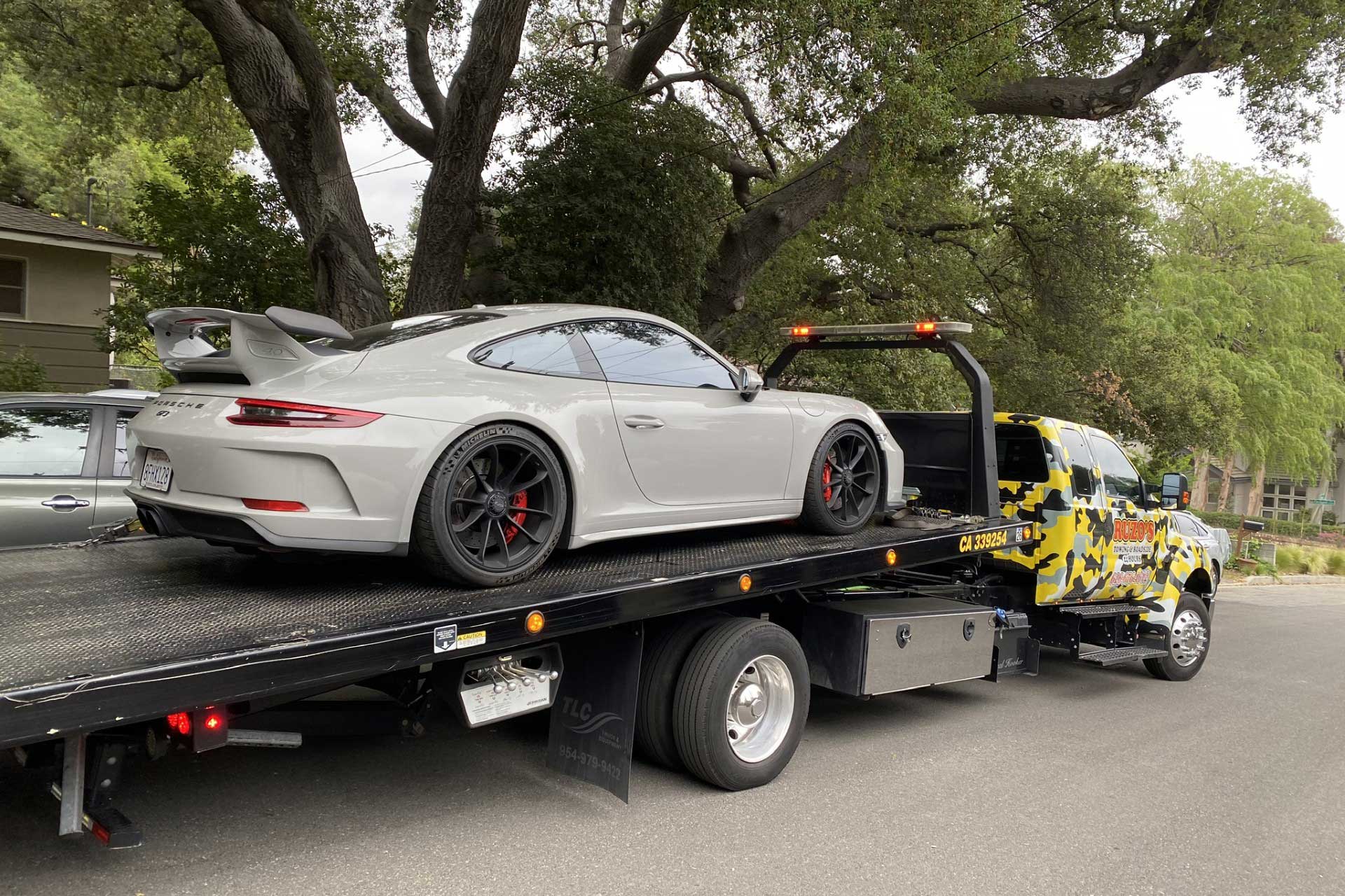 porsche 911 gt3 being towed on a flatbed