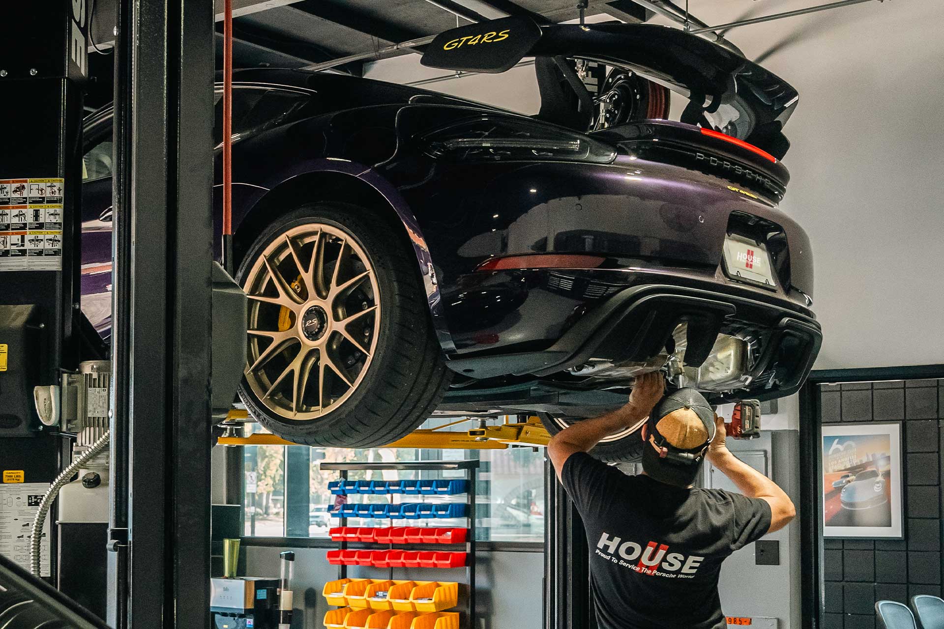 house automotive tech installing exhaust on porsche gt4 rs